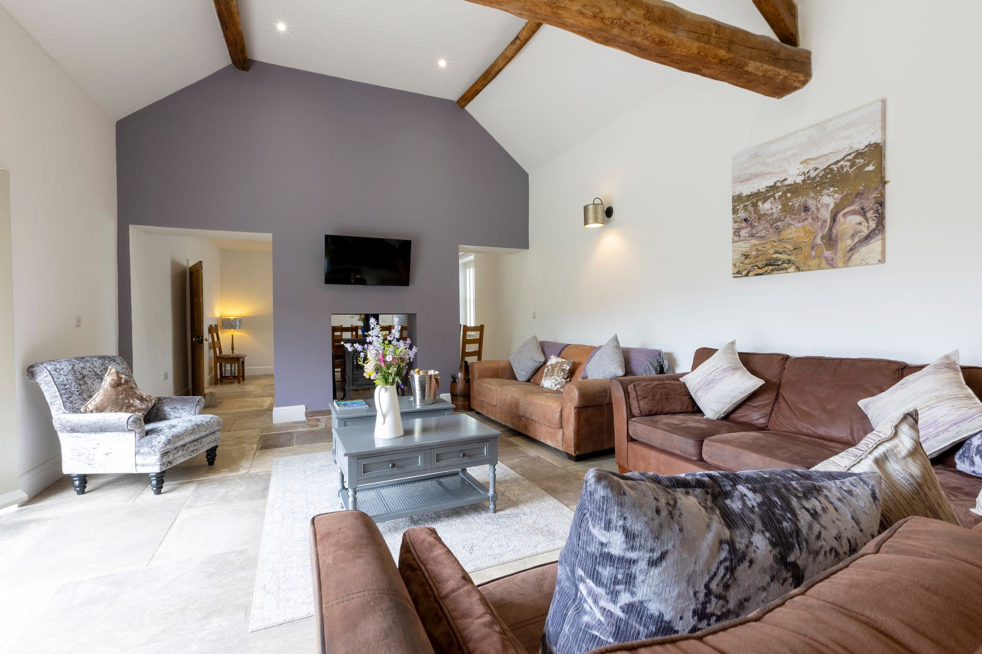 A bathroom with a bathtub , sink , chair and window.