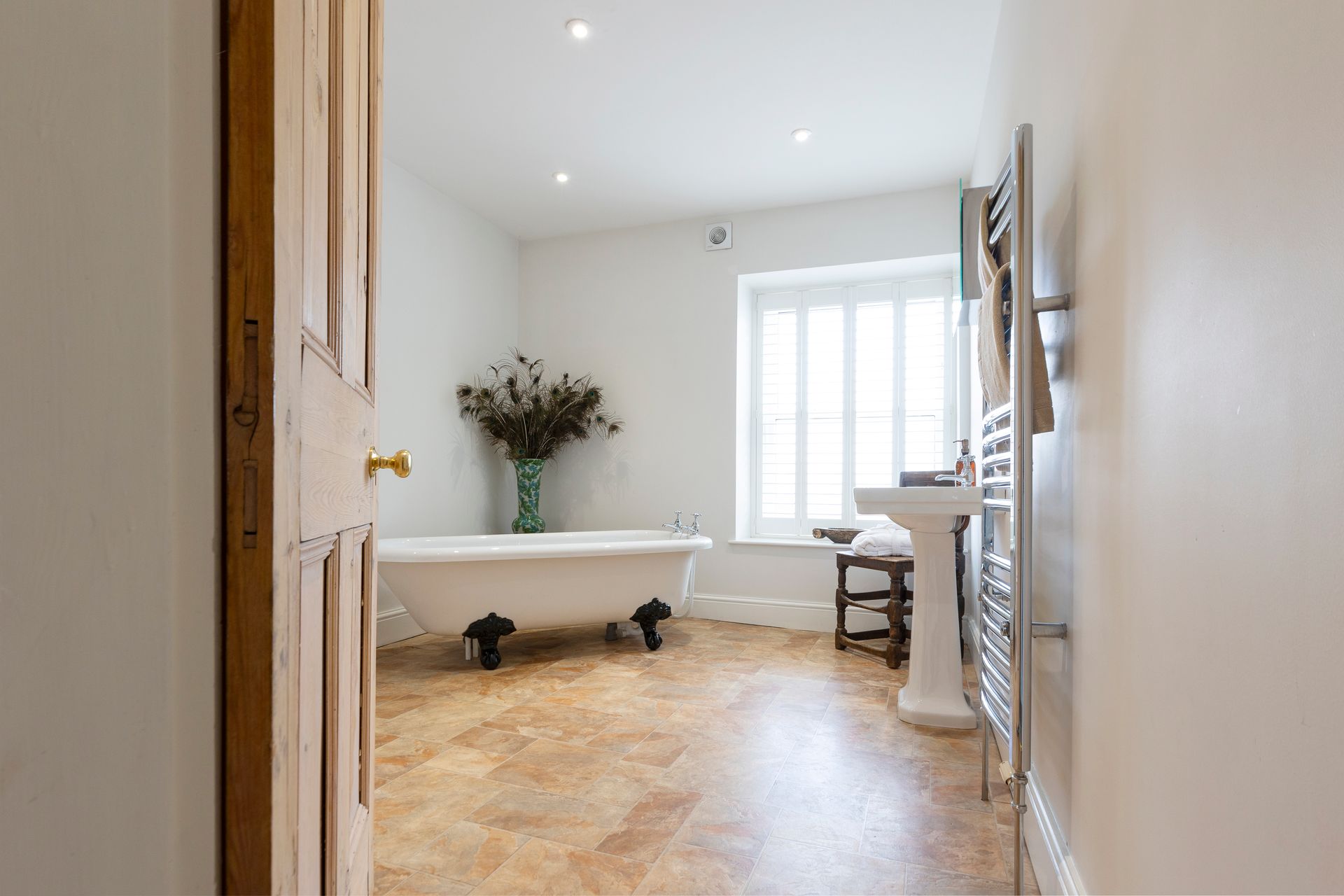 A bedroom with two beds and a clock on the wall.