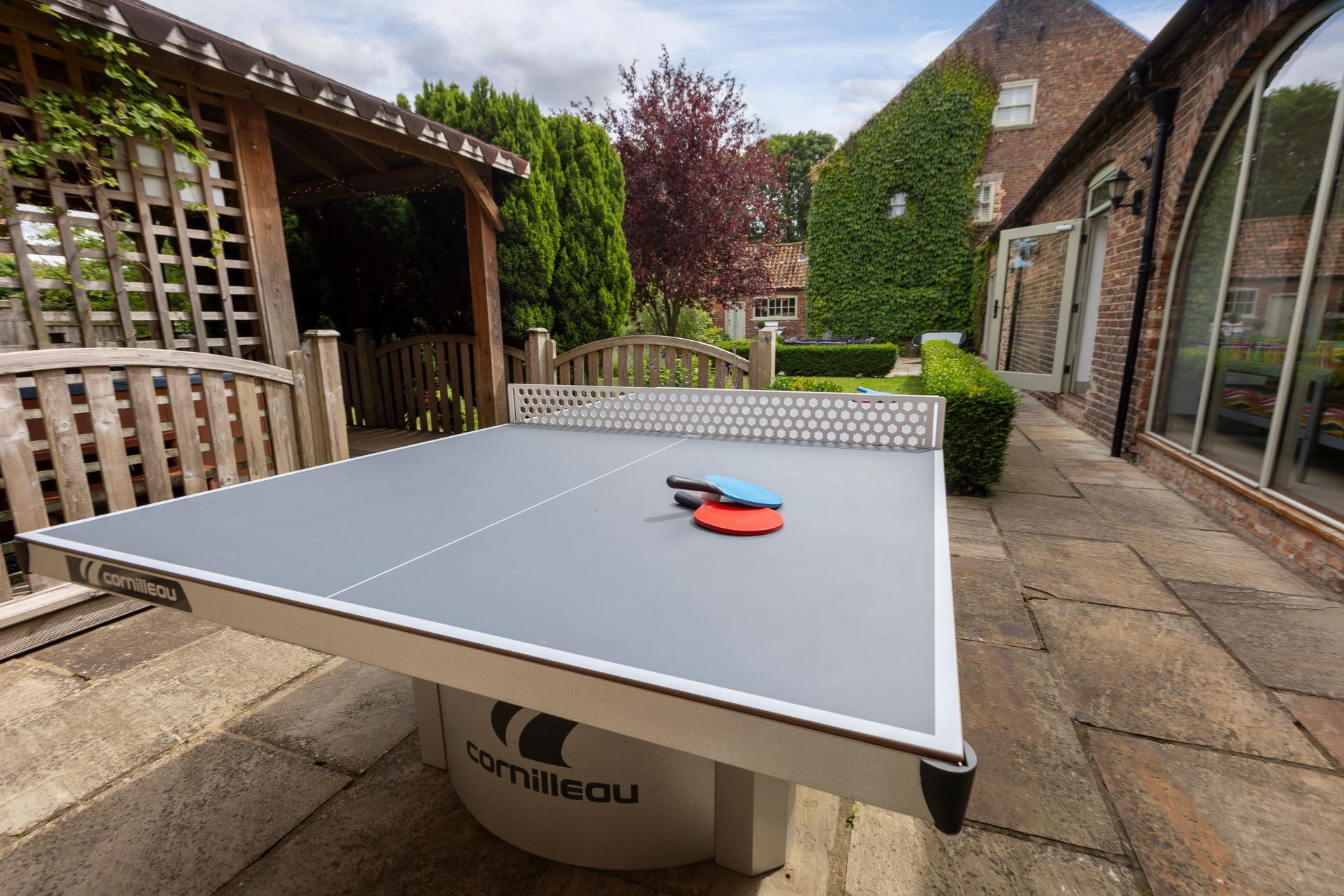 A kitchen with a large island in the middle and a clock on the wall.
