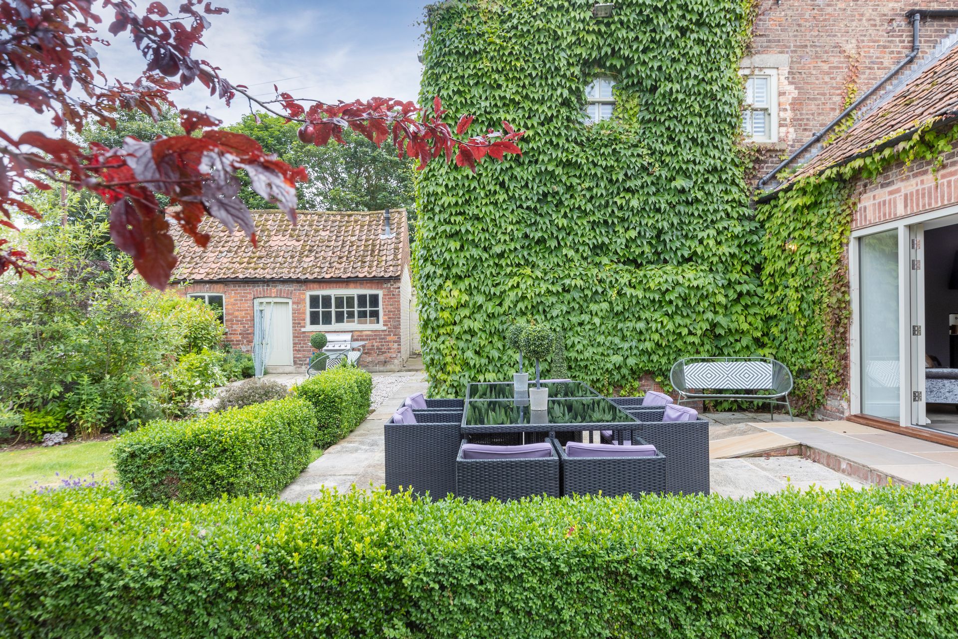 A dining room with a long wooden table and chairs.