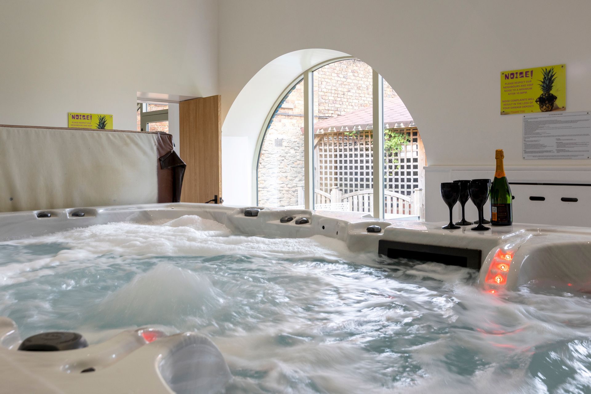 A kitchen with a large island in the middle and a clock on the wall.