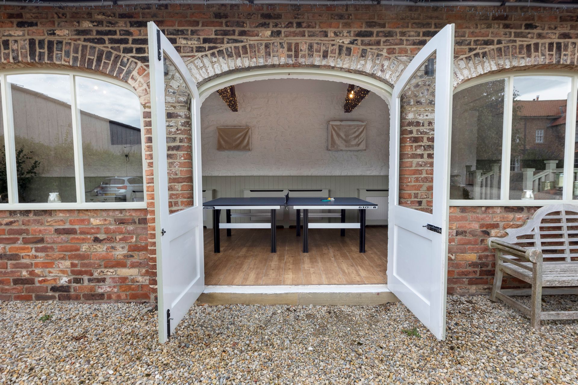 A dining room with a long wooden table and chairs.