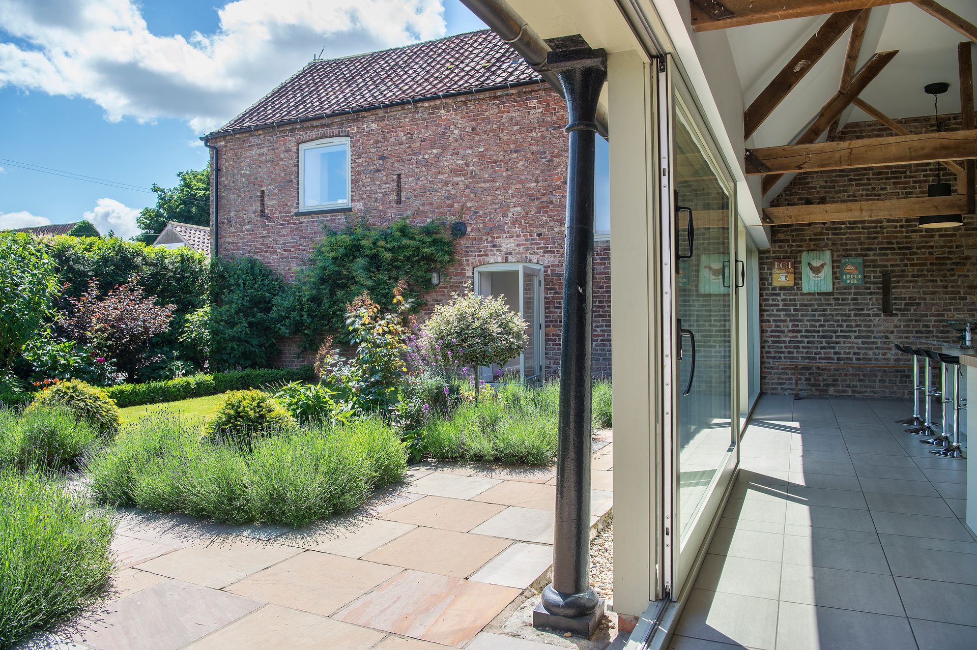 A bedroom with two beds and two lamps