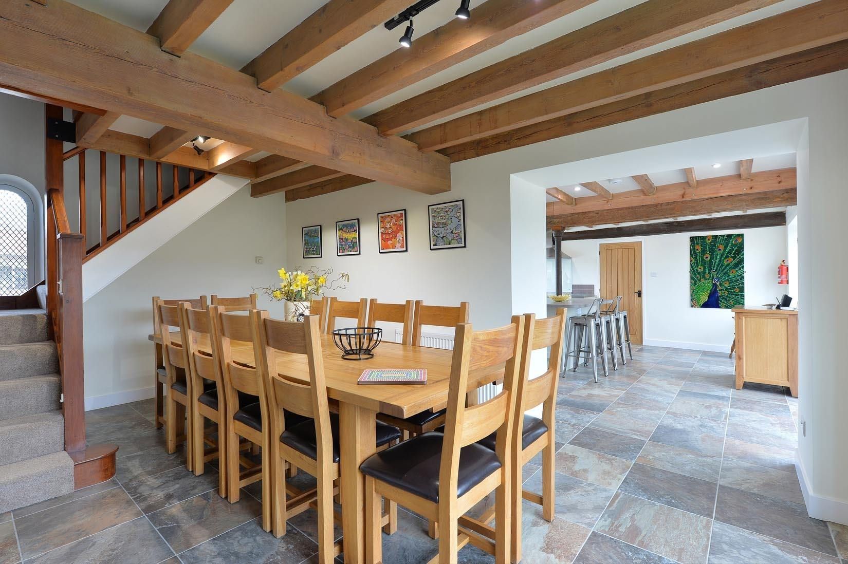 A dining room with a long wooden table and chairs