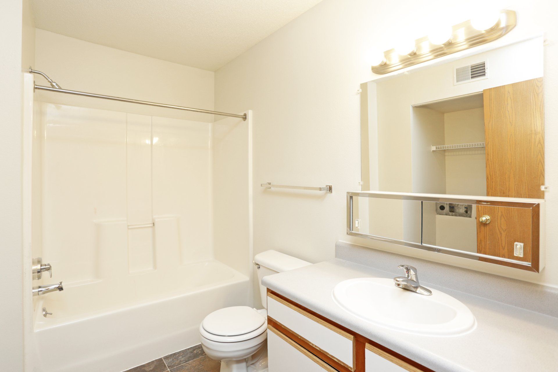 Bathroom with white fixtures and shower/tub combo