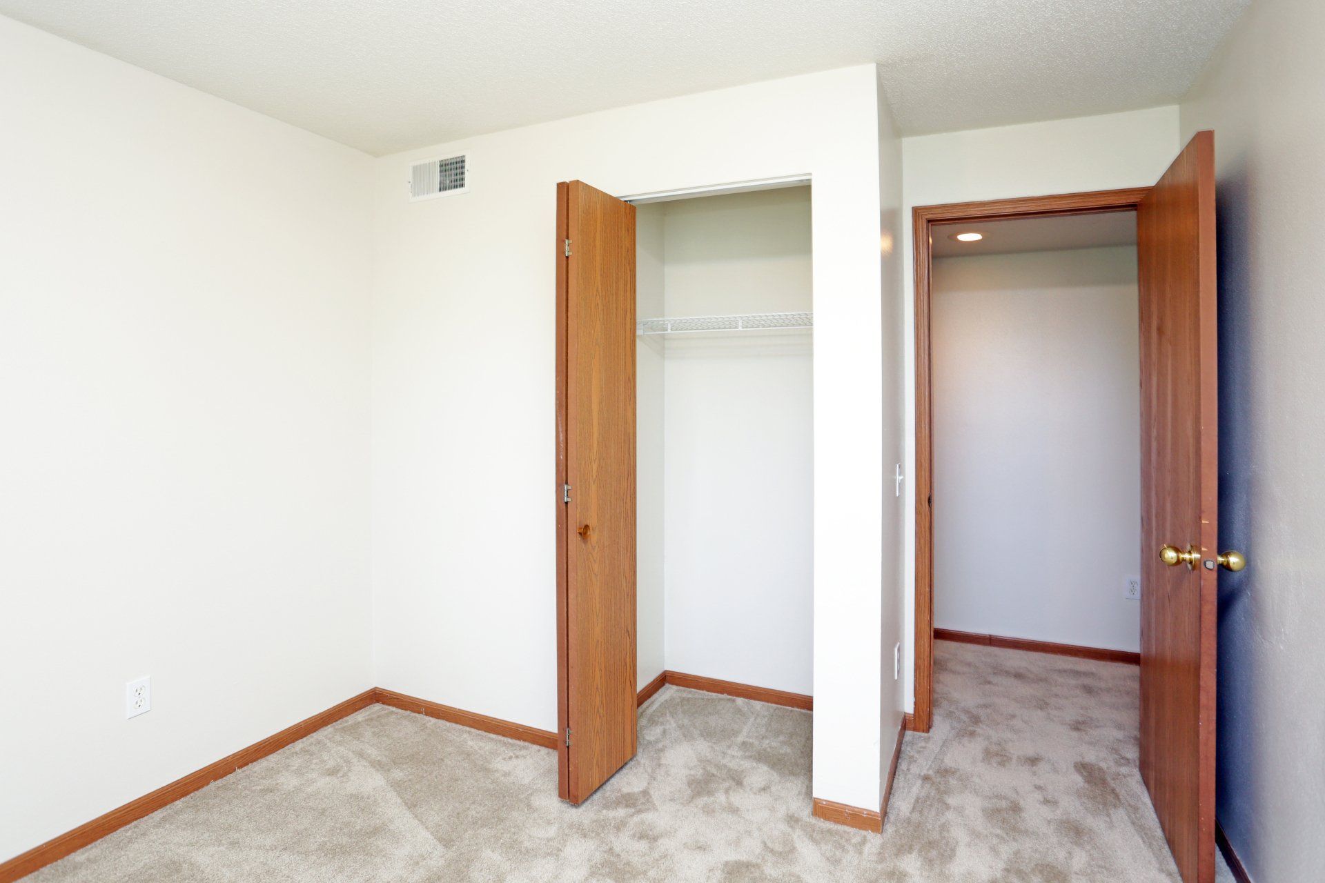 Alternate bedroom view of closet and hallway