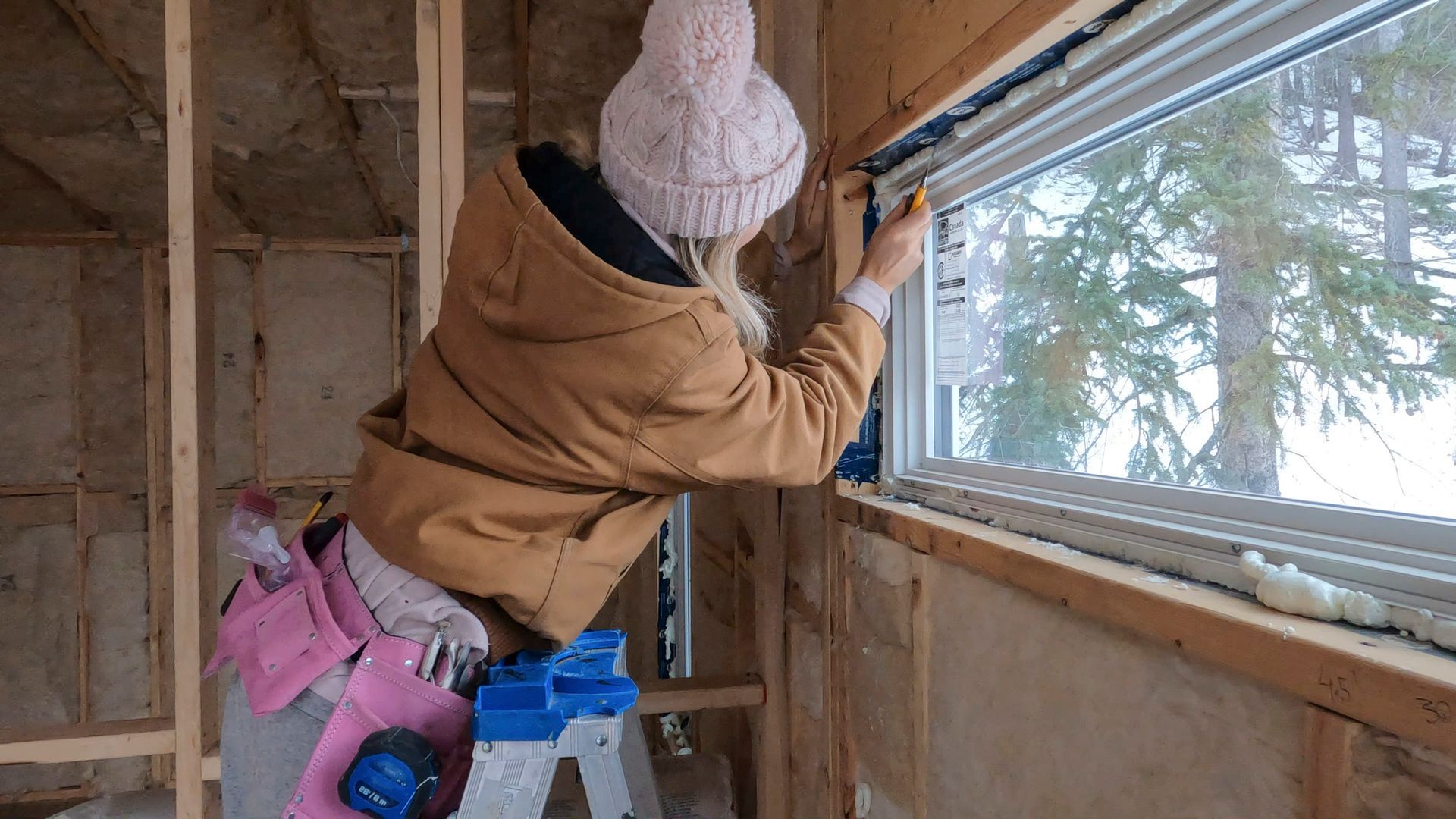 Grant AC technician sealing attic insulation & checking air leaks in Mississippi home during winter.