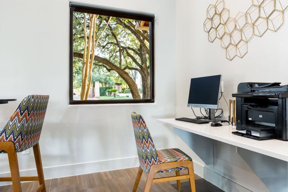 a room with a desk, chairs, computer, and printer at Marquis at Great Hills in Austin, TX.