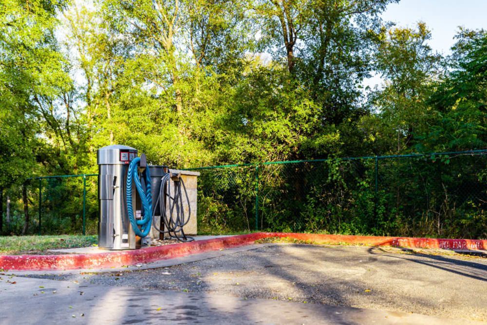 a car wash in a parking lot with trees in the background at Marquis at Great Hills in Austin, TX.