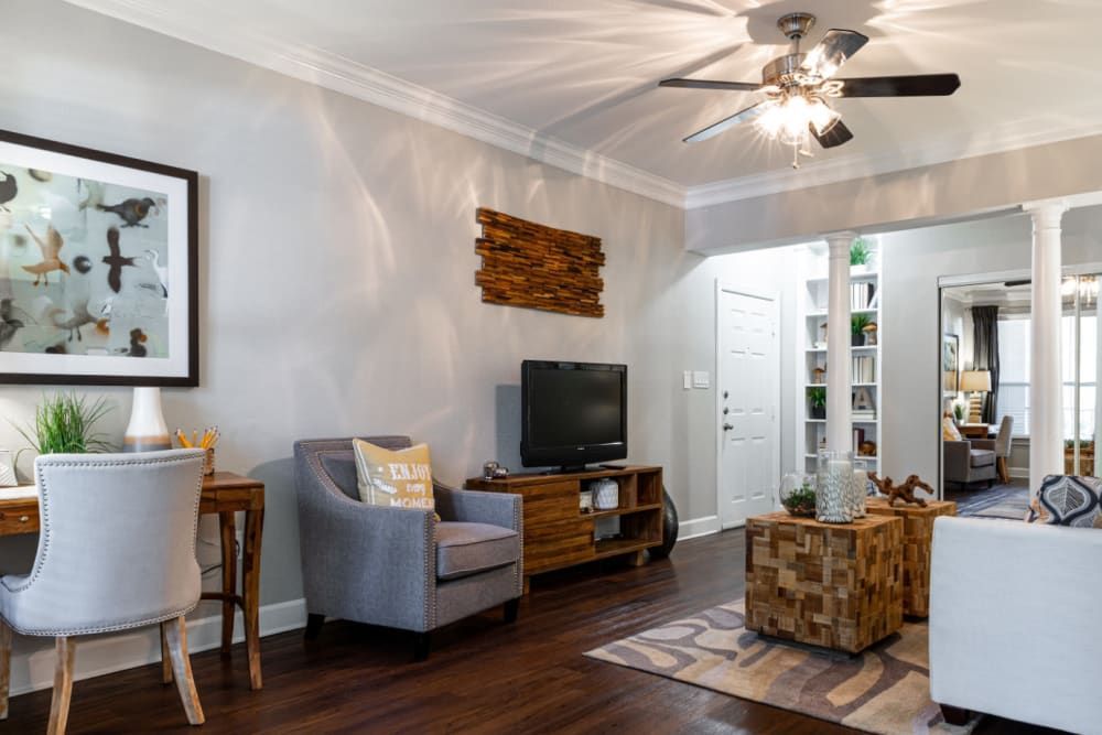 a living room filled with furniture and a ceiling fan at Marquis at Great Hills in Austin, TX.