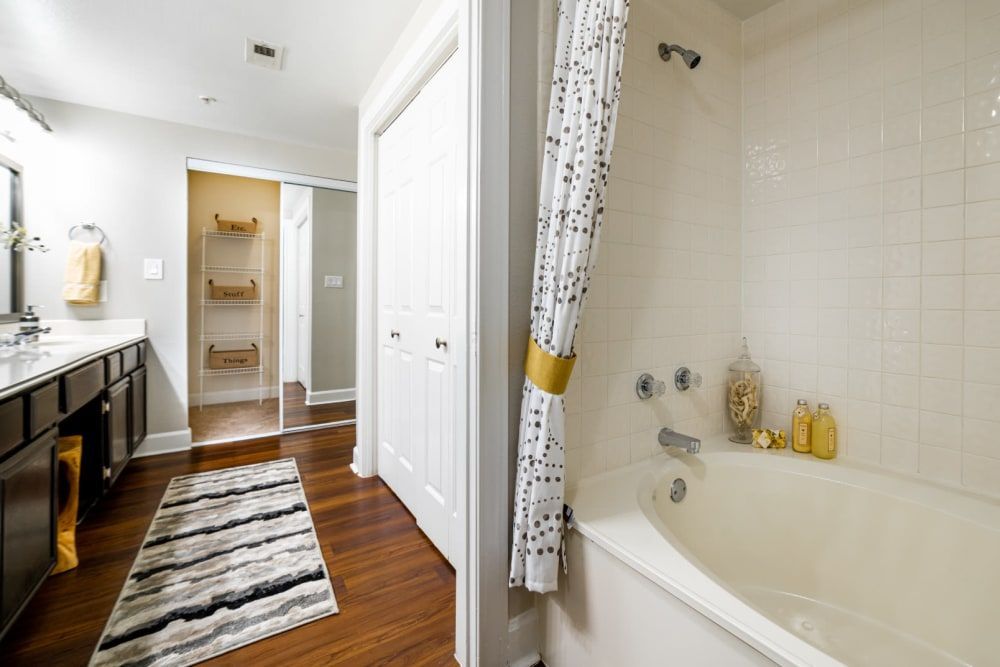 a bathroom with a bathtub, sink, and shower at Marquis at Great Hills in Austin, TX.