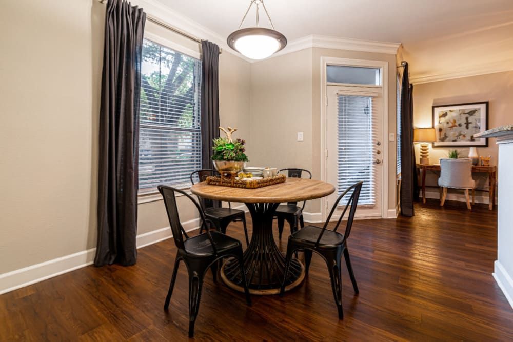 a dining room with a wooden table and chairs at Marquis at Great Hills in Austin, TX.