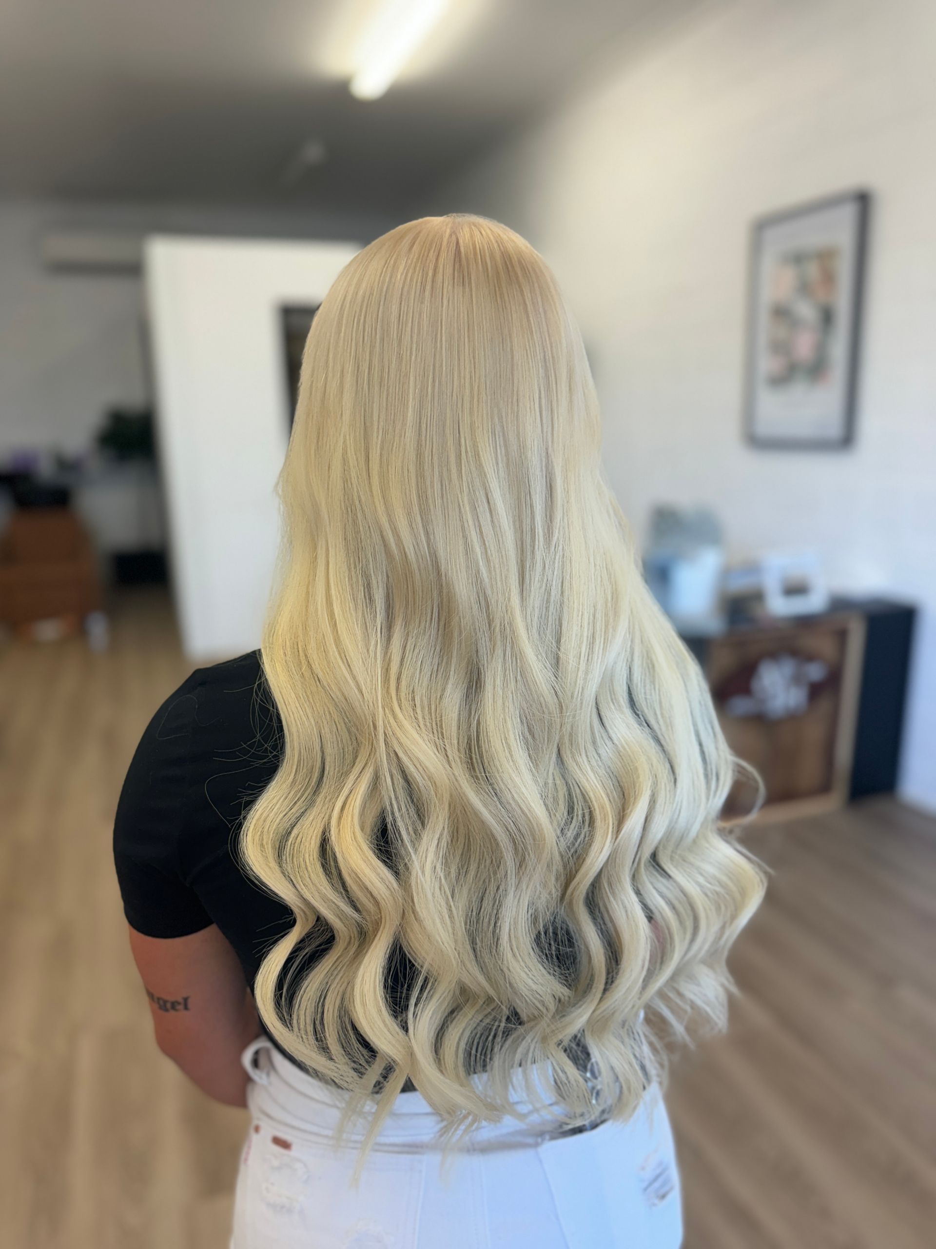 A Woman With Long vibrant red Hair is Standing in a Salon — Atelier Of Hair in Grafton, NSW