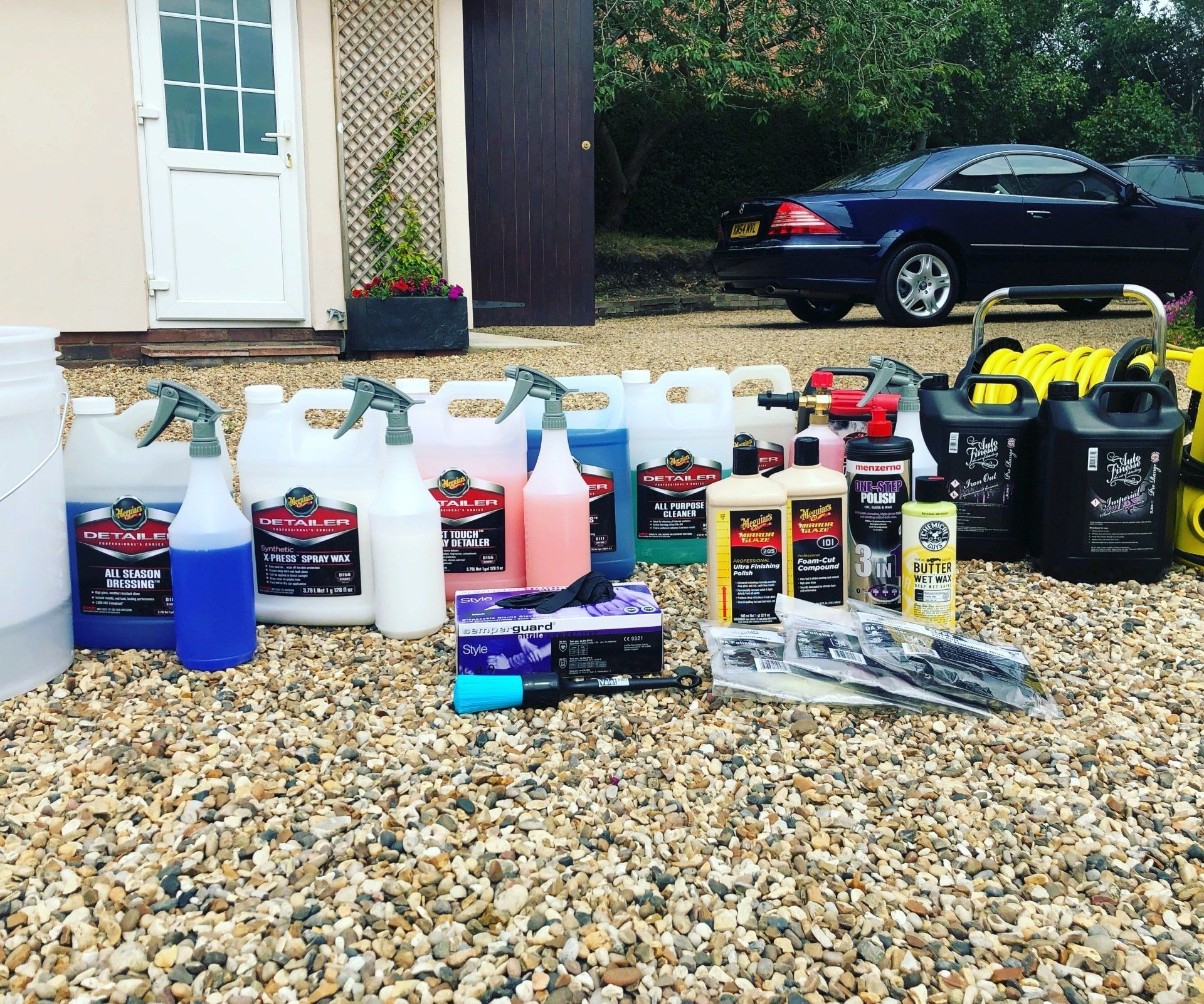 Car cleaning products with Mercedes Benz CL500 in background.