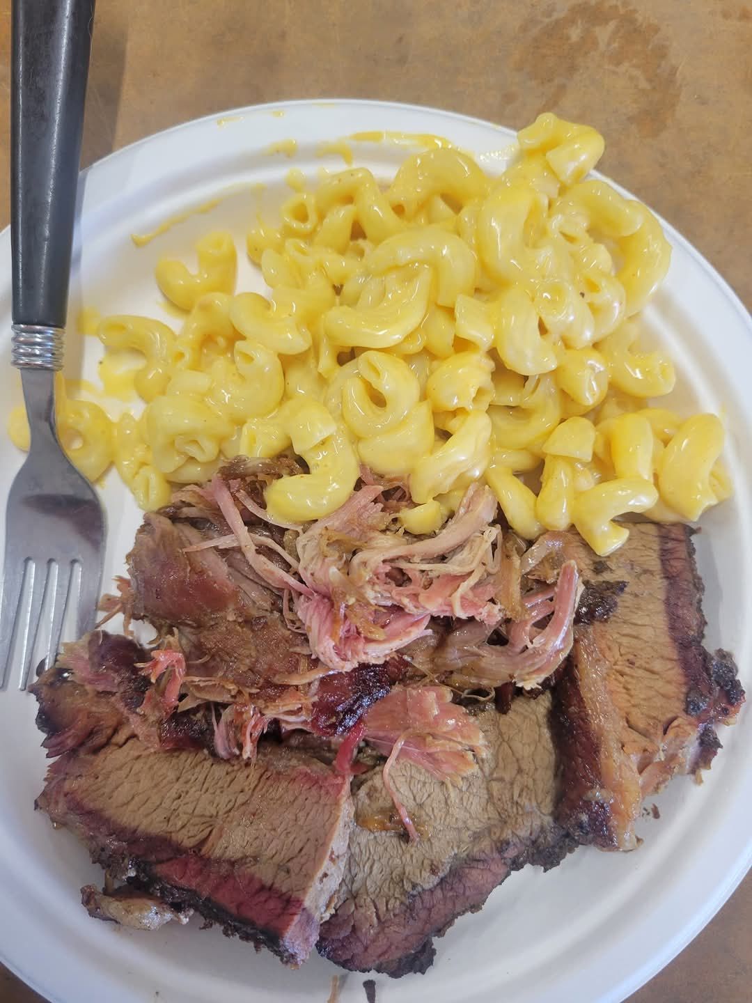 Plate of BBQ brisket, pulled pork, and mac and cheese.