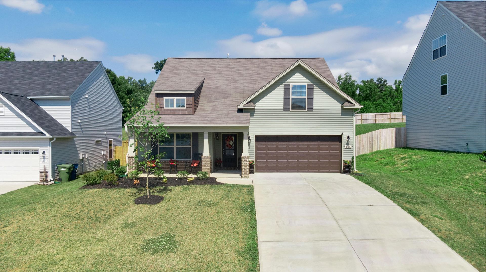 An aerial view of a house with a garage and a driveway.