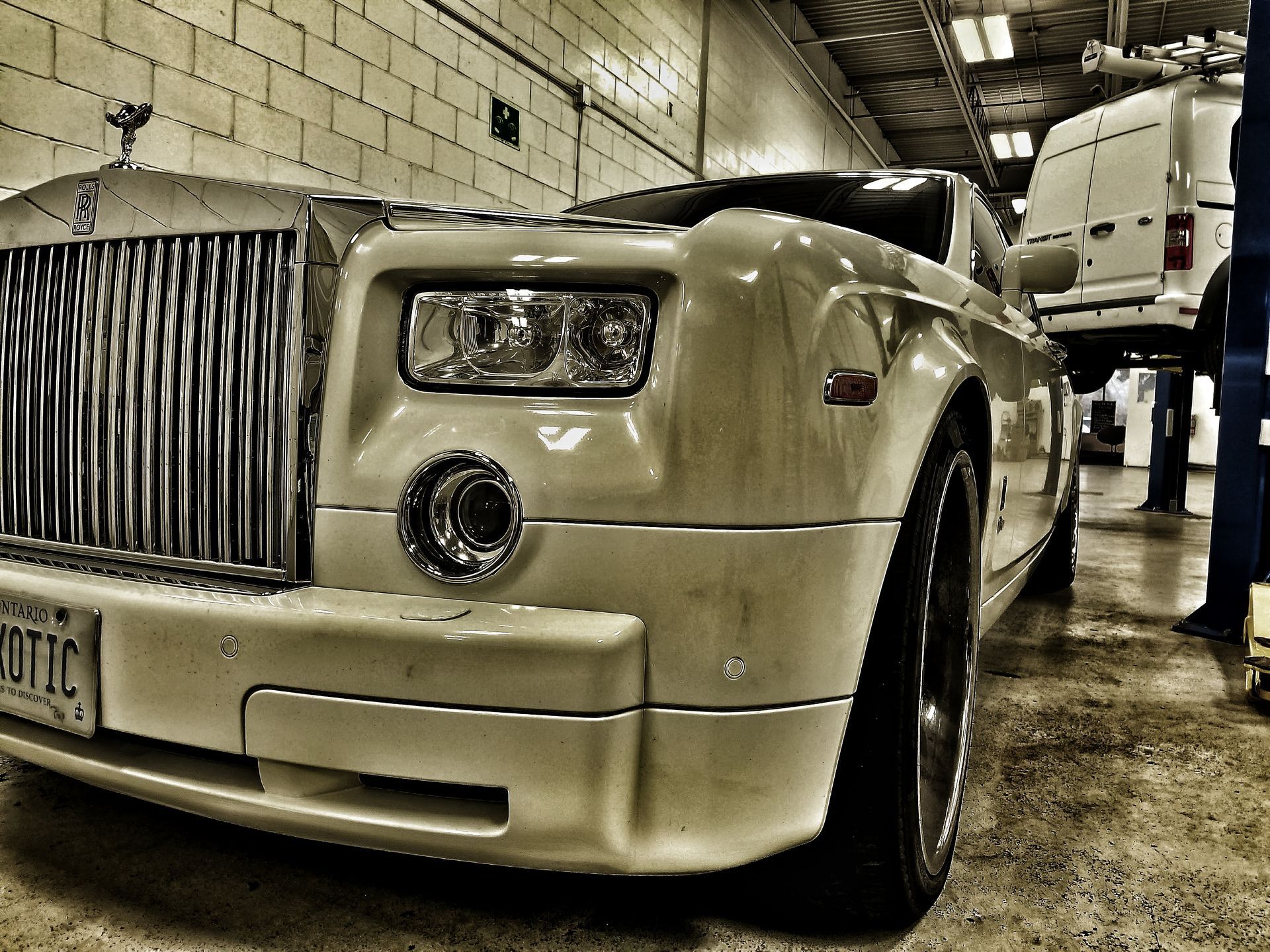 Cream-colored Rolls-Royce parked in a garage, with the