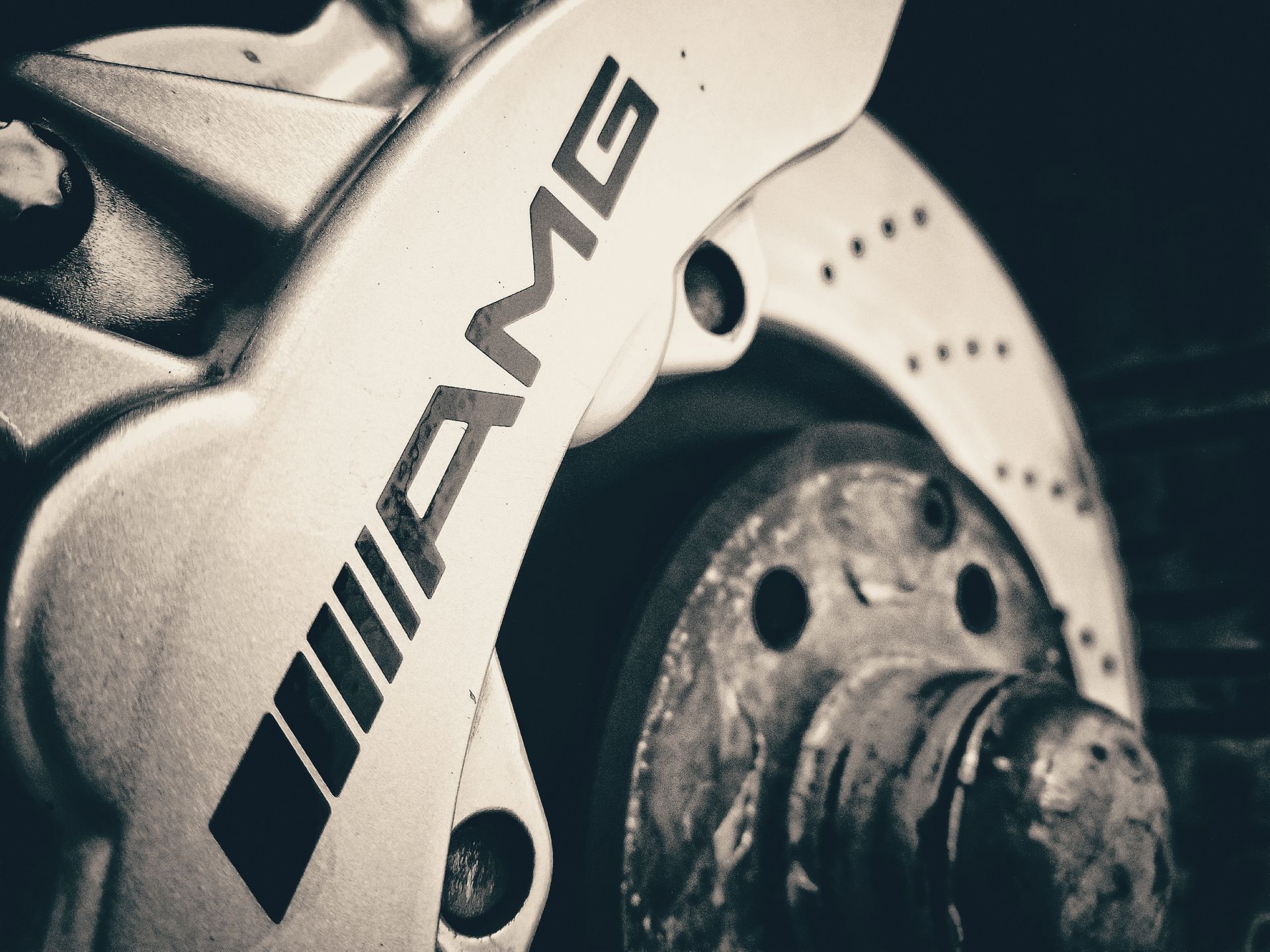 AMG brake caliper and rotor on a vehicle.