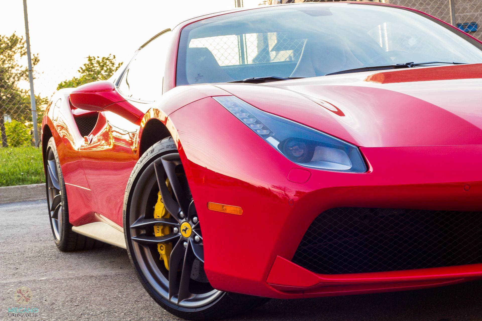 Red Ferrari sports car with black wheels and yellow brake calipers. | Mecano Autoworks