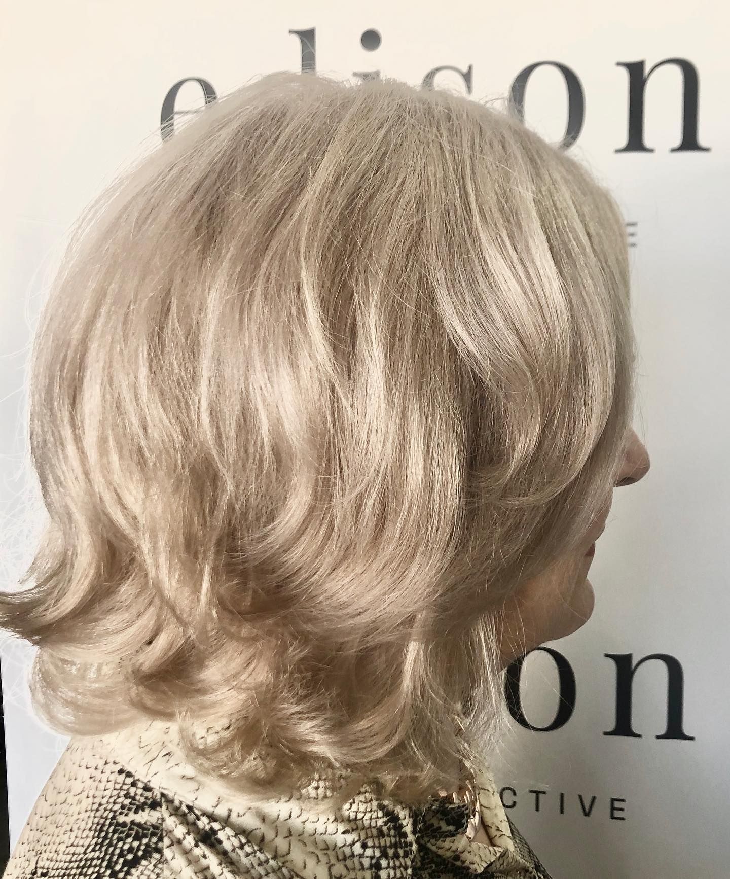 Blonde Wavy Bob Haircut, Side View, on Person Wearing Patterned Top, Near a White Wall — EDISON Hair Collective In Mackay, QLD