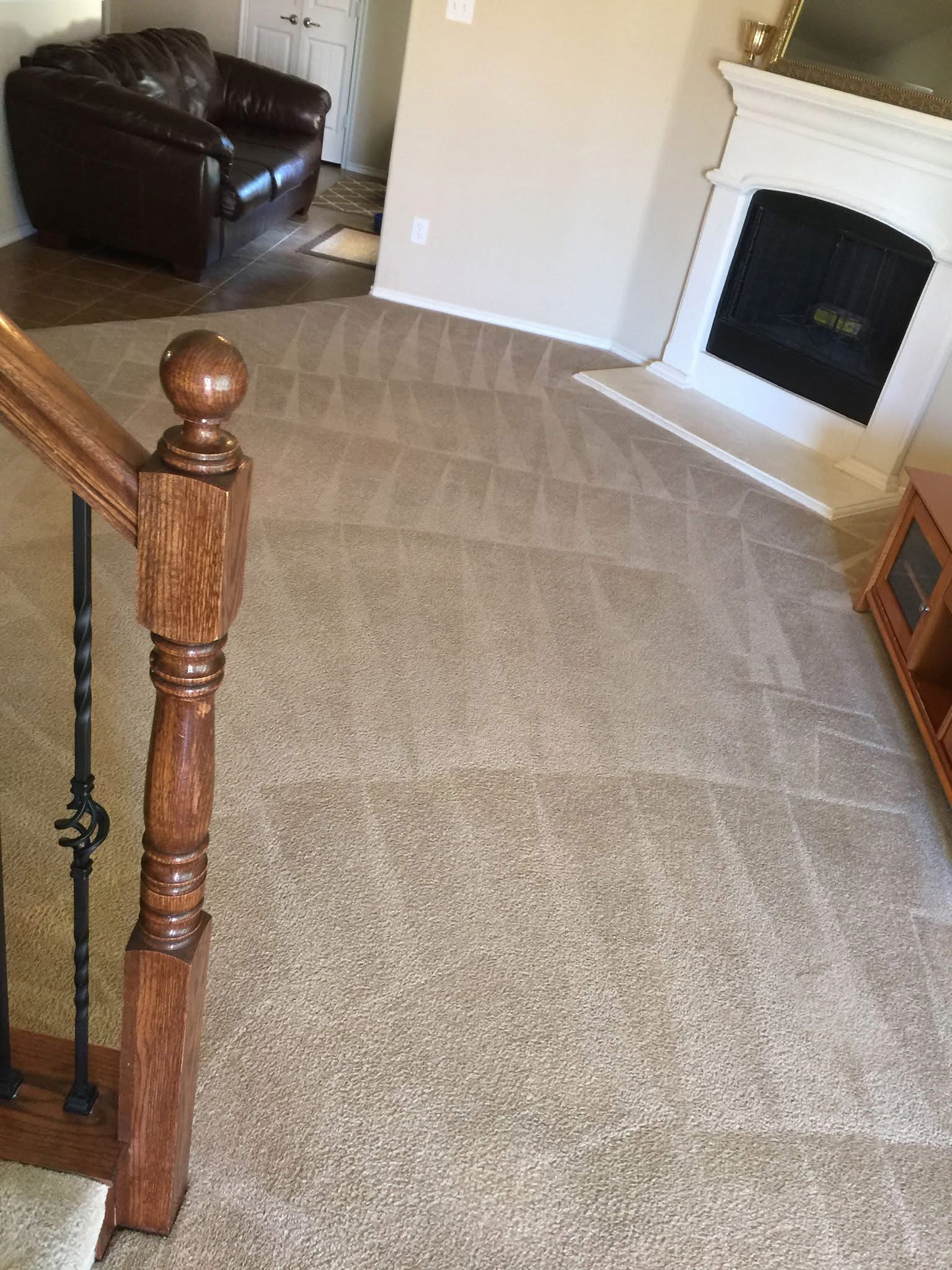 A large room with a carpeted floor and a window.