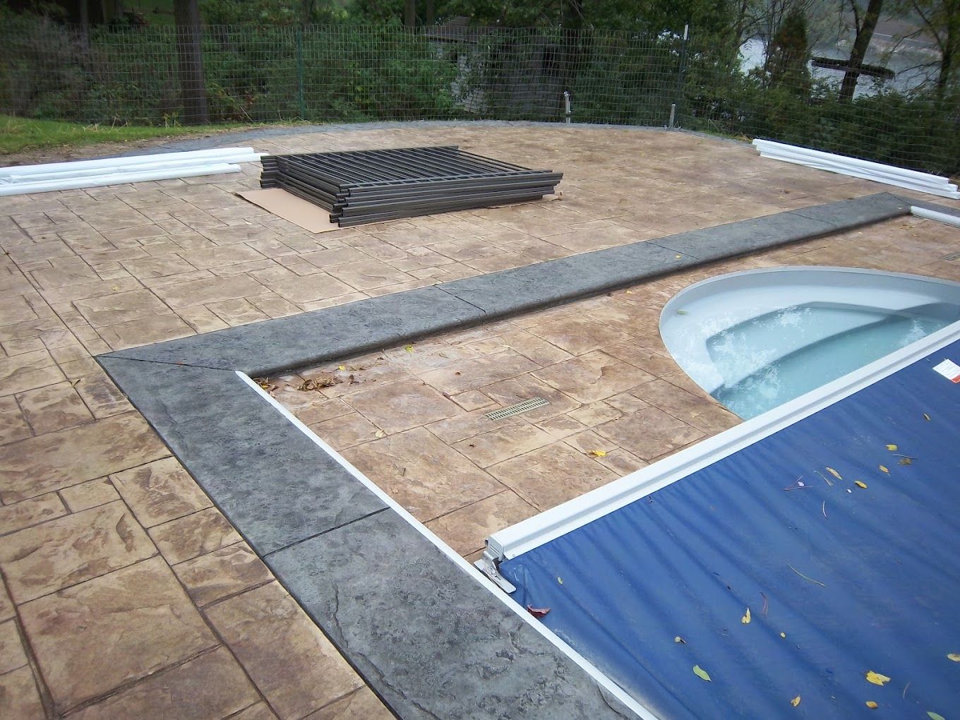 A swimming pool with a blue cover on it