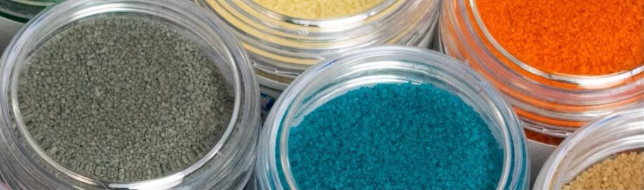 A group of jars filled with different colored powders.