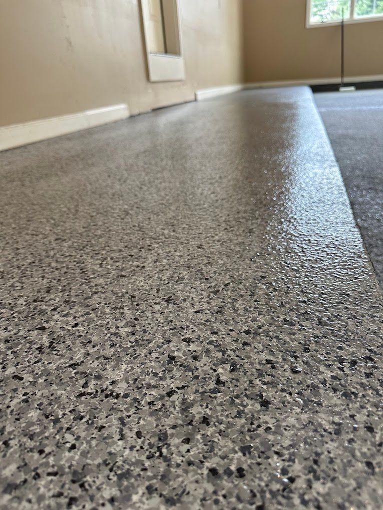 A close up of a gray concrete floor in a room.