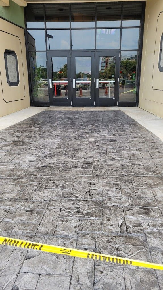 A large building with a concrete walkway in front of it