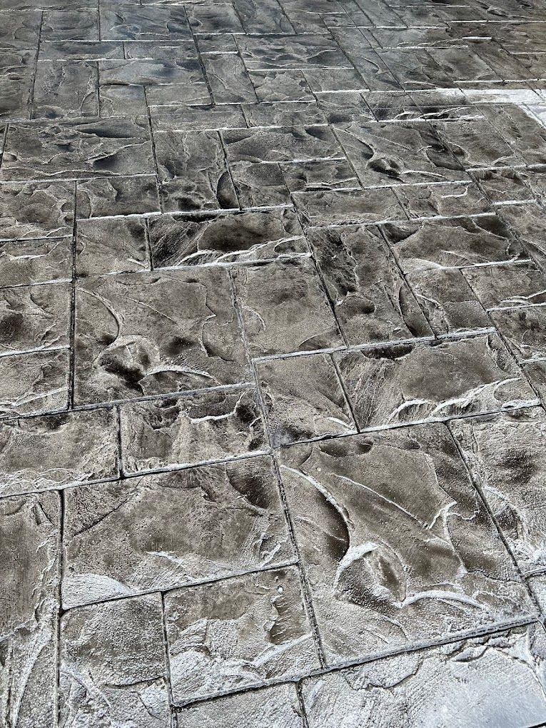 A close up of a brick floor with footprints on it.