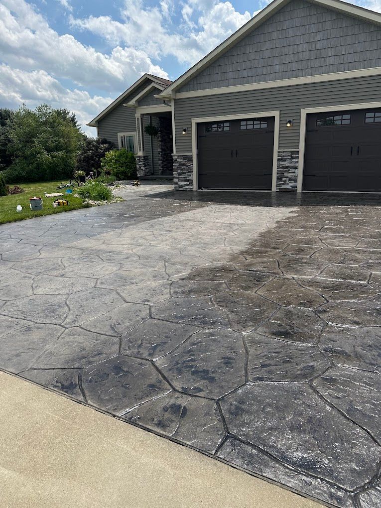 A house with a concrete driveway in front of it
