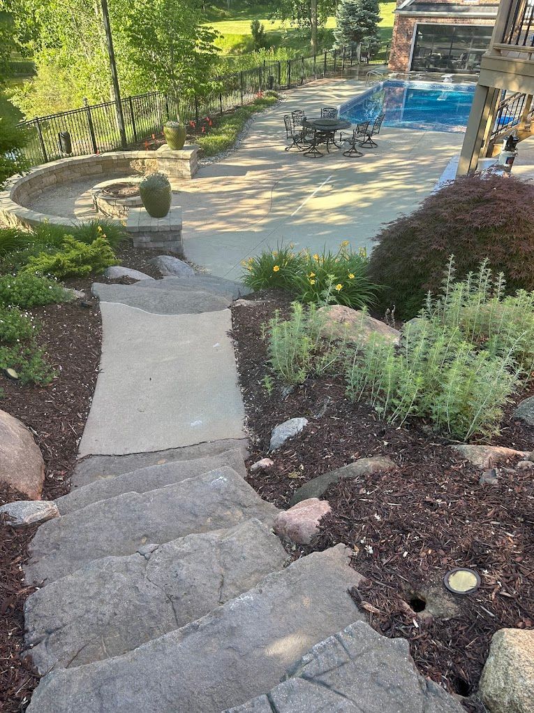A staircase leading up to a swimming pool in a backyard.