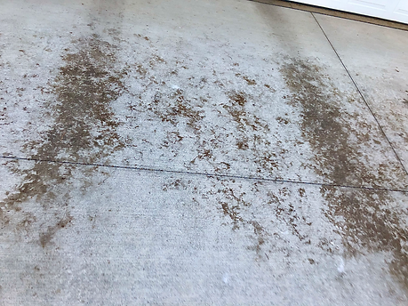 A dirty concrete floor with a lot of dirt on it.