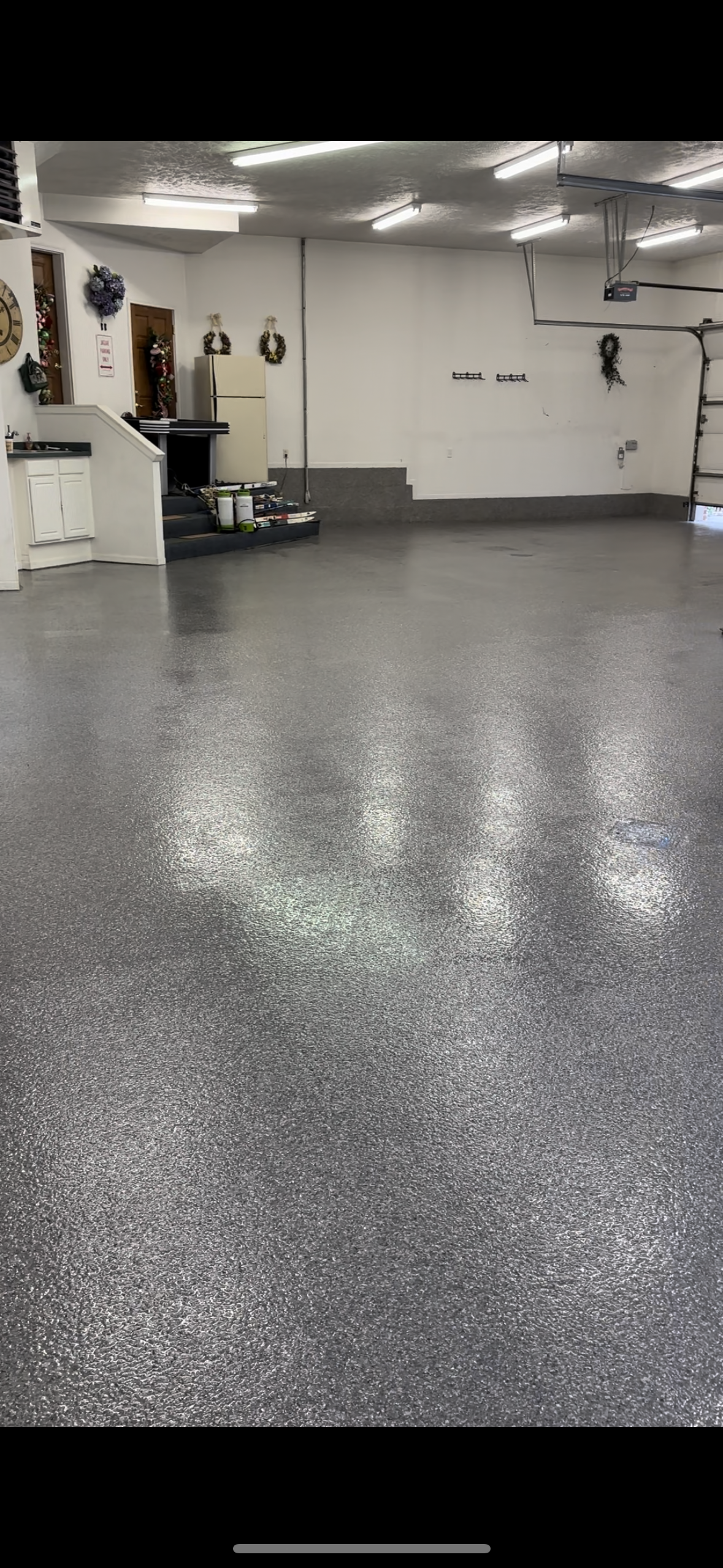 A garage with a gray floor and white walls.