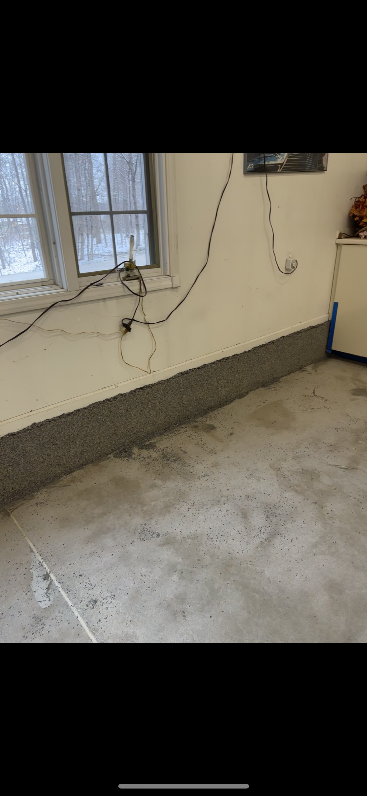 A room with a concrete floor and a window.