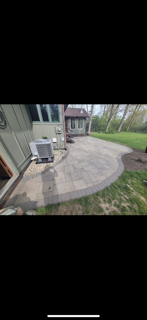 A patio with a gazebo in the backyard of a house.