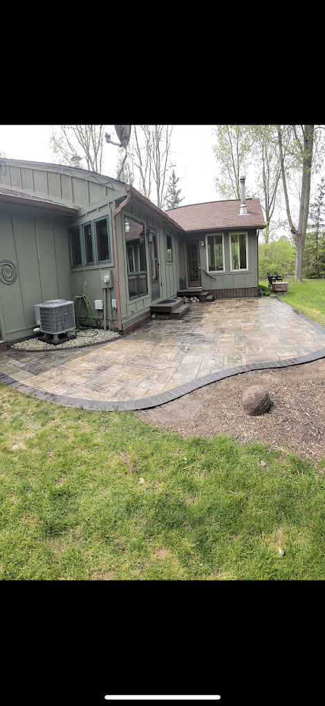 A house with a concrete driveway in front of it.