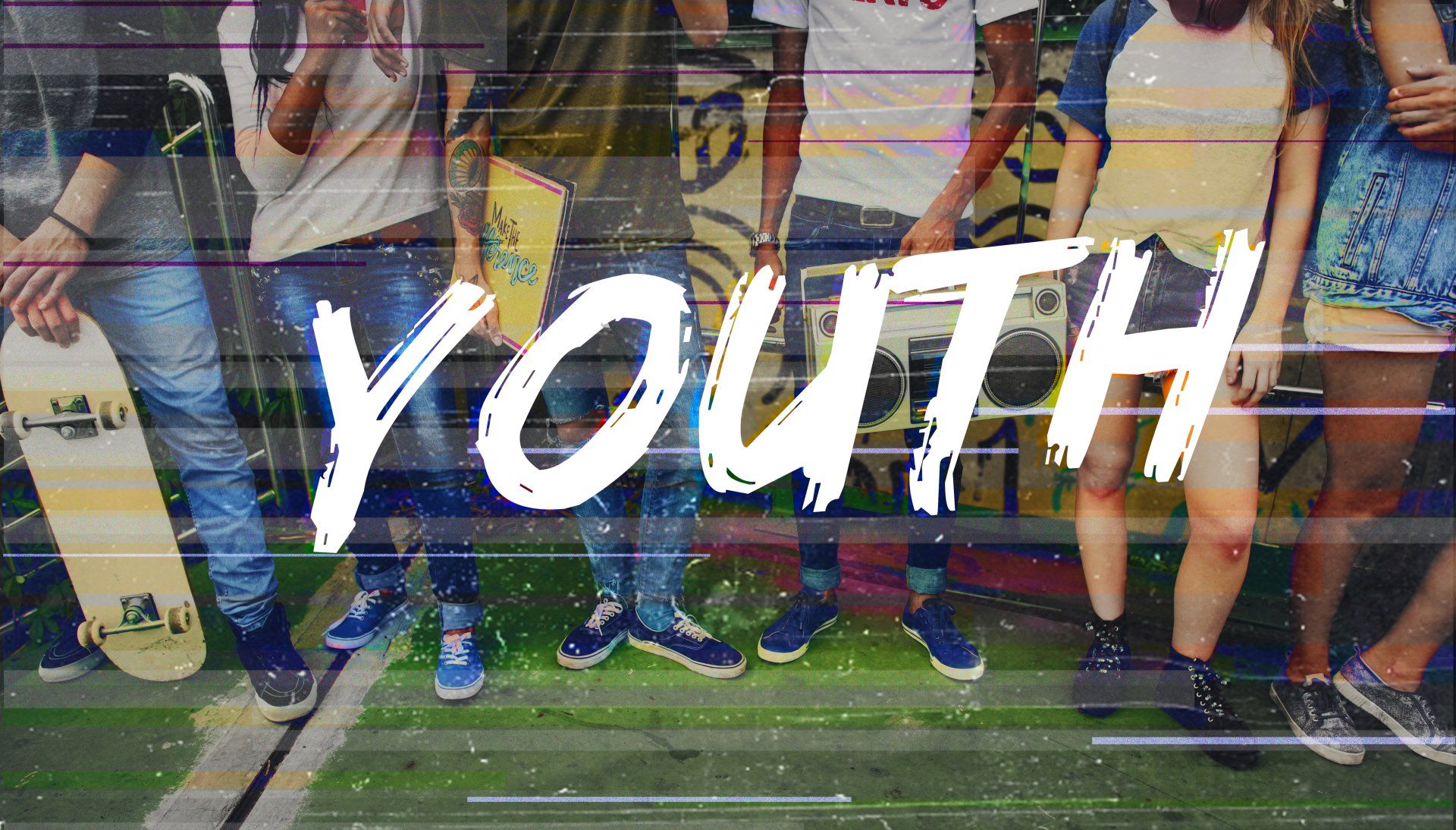 A group of young people standing next to each other in front of a wall with the word youth written on it.