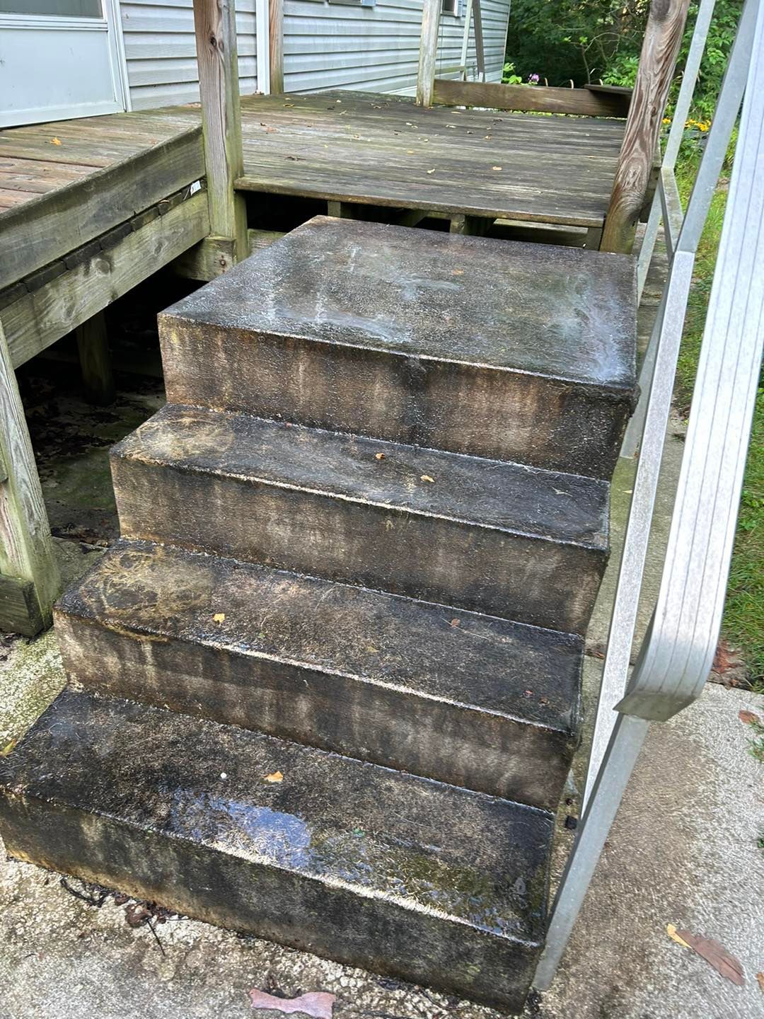 A set of stairs leading up to a wooden deck.