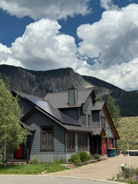 A large wooden house with a metal roof