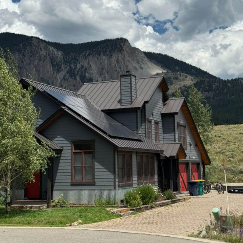 A large wooden house with a metal roof