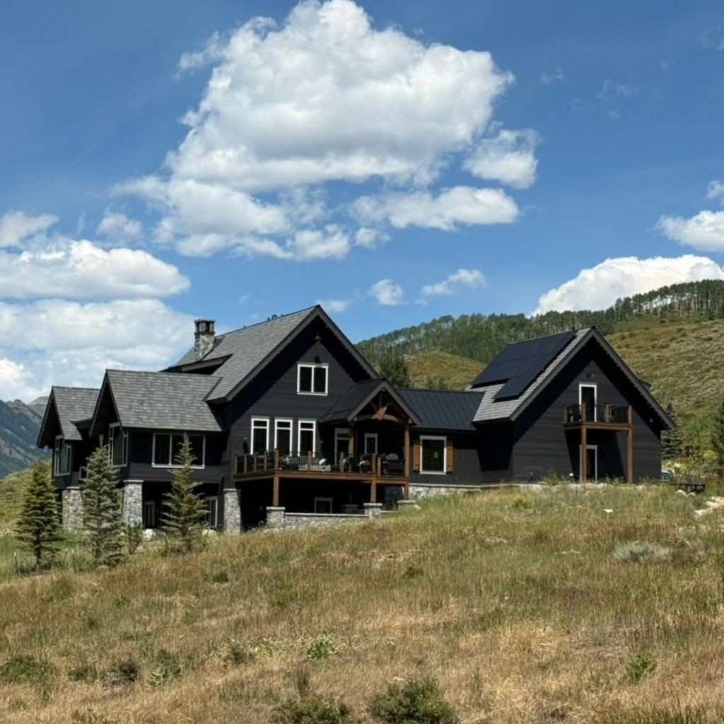 A large house with a metal roof is being built