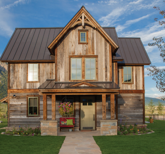 A large wooden house with a metal roof