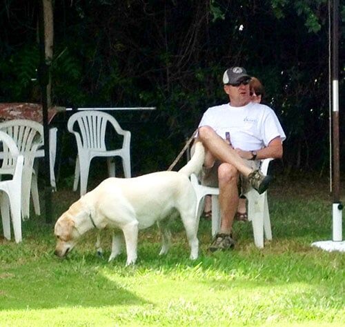 dog and a man sitting - Dog Obedience Training in Sylmar, CA