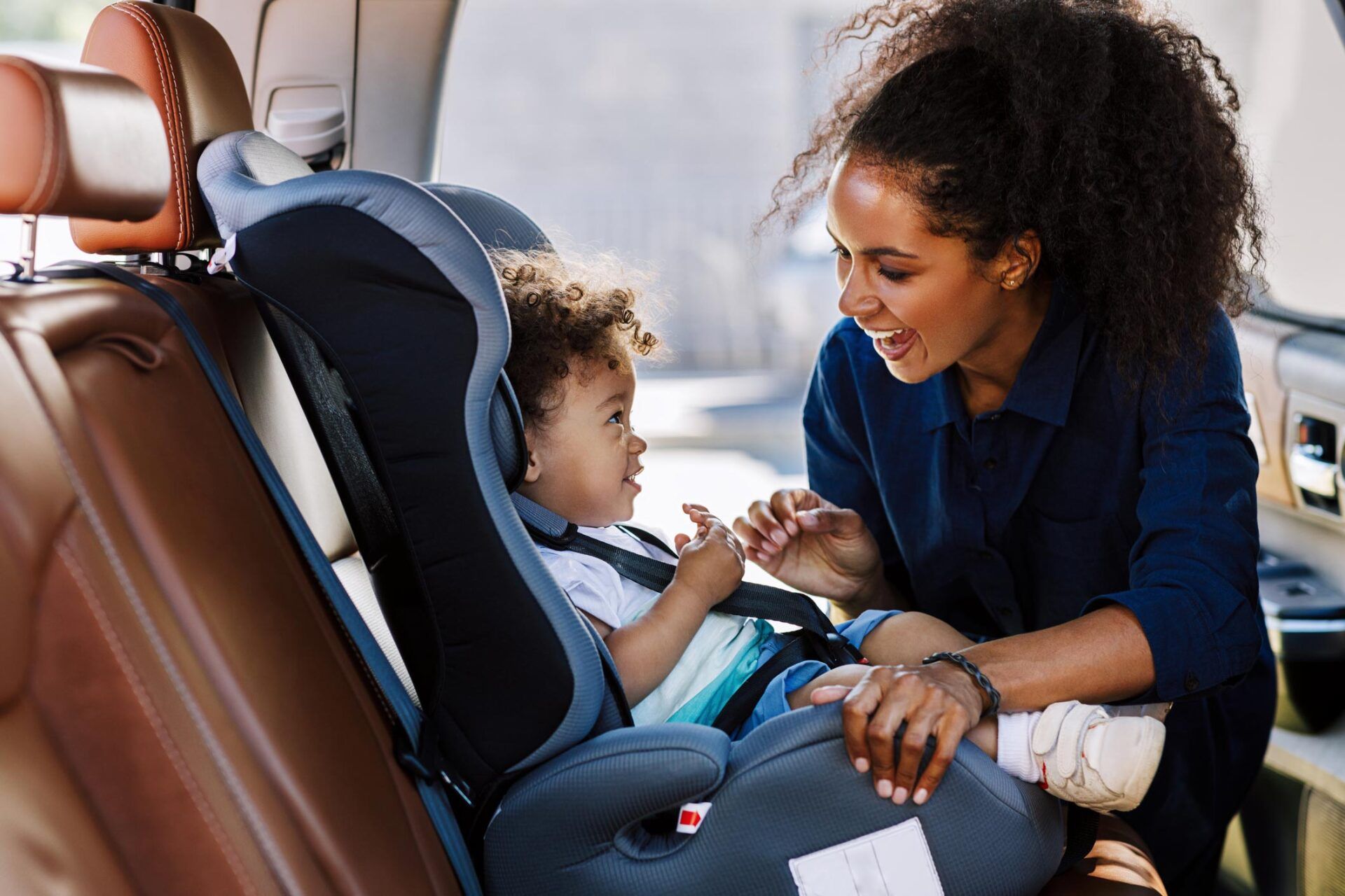 Mother Securing Child in the Car Seat — Homestead, FL — South Dade Auto Tag Agency