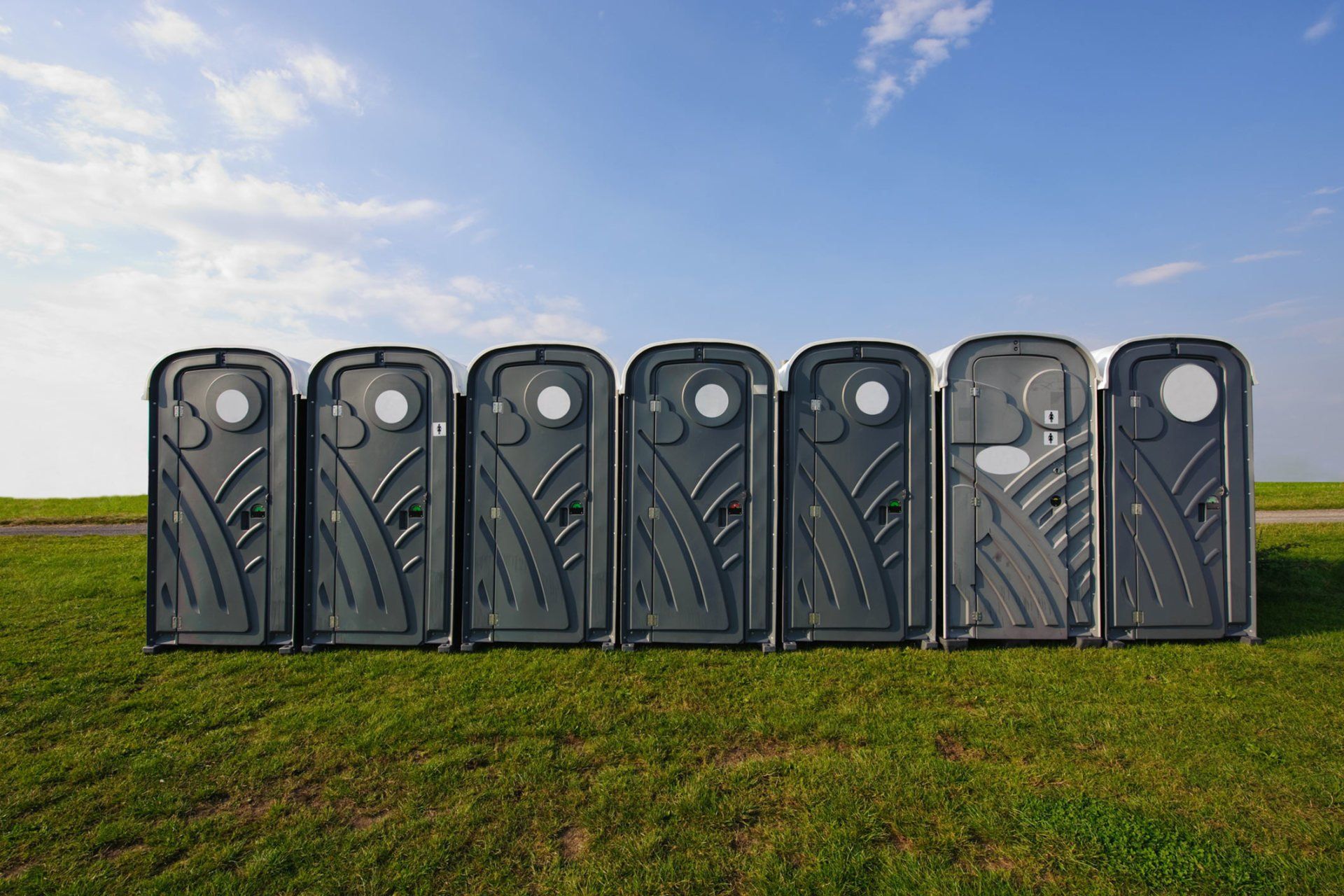 A row of portable toilets for waste management services in Lynchburg, VA