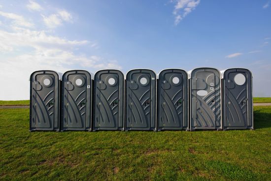 A row of portable toilets for waste management services in Lynchburg, VA