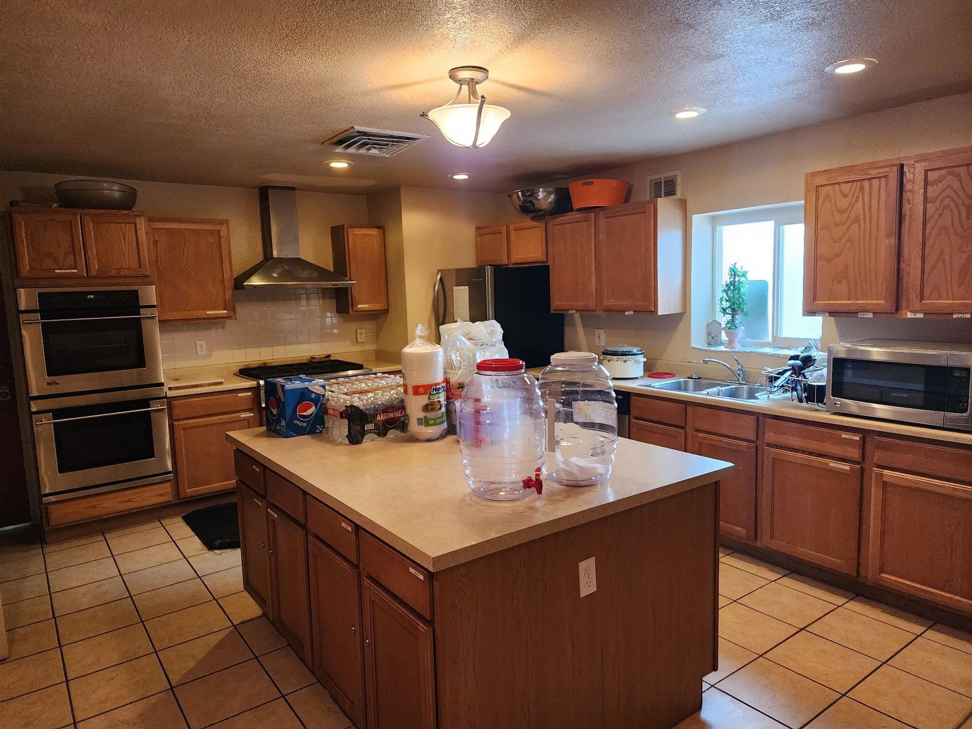 Kitchen with wood cabinets, stainless steel appliances, and island.