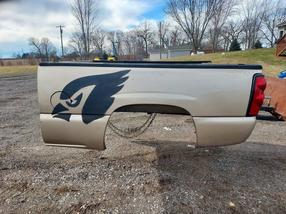 The back end of a truck with a bird on it