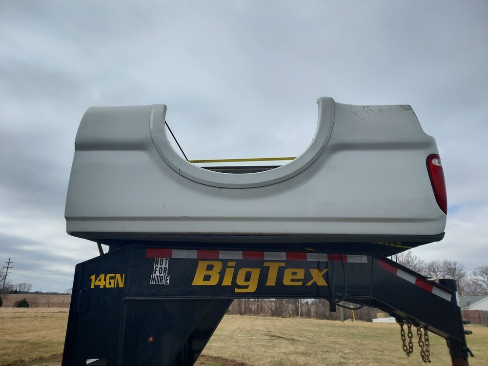 A big tex truck bed is sitting on top of a trailer